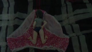 The slutty little Asian girl was sitting on the edge of her bed, playing with her pussy