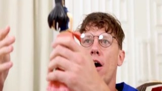 The eager nerd kneeled down in front of the sexy anime doll, his eyes wide with desire as he fumbled with her delicate panties